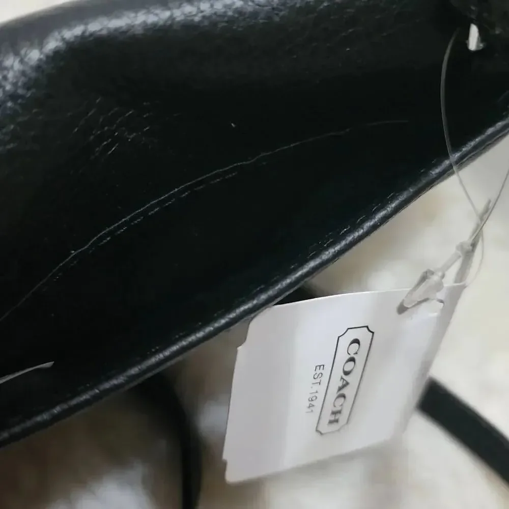 Coach Avery leather phone crossbody w/ a flap closure.